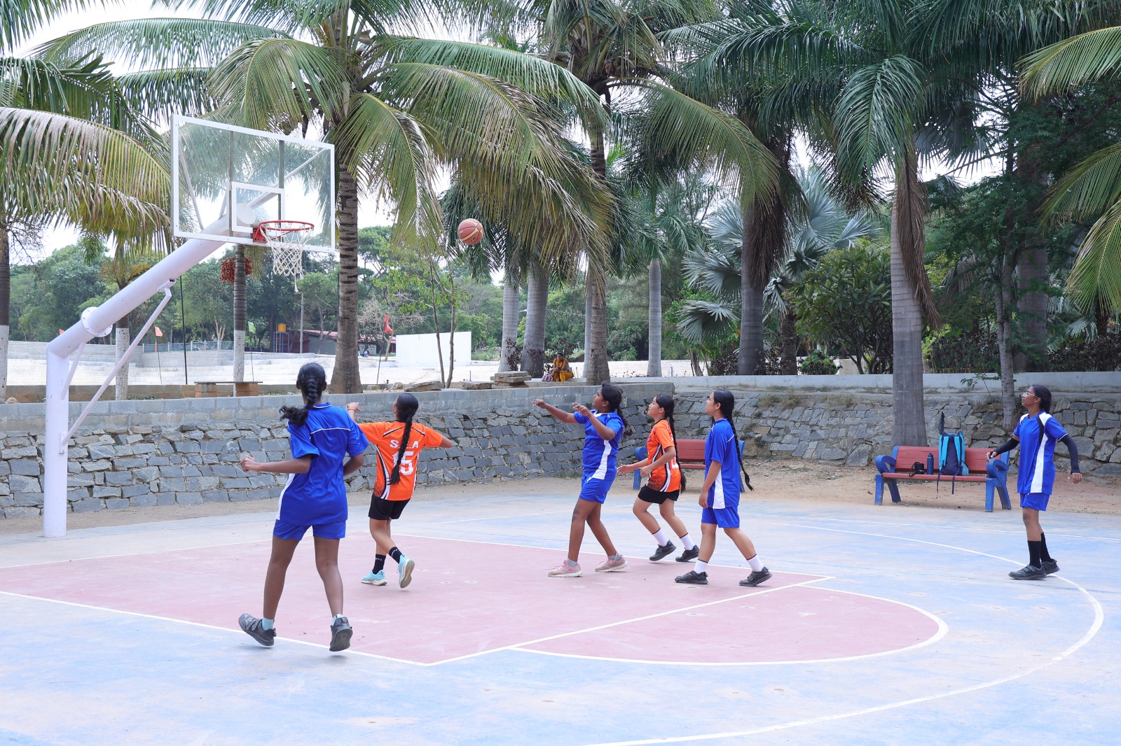 Secondary students playing basketball